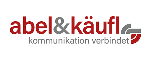 The logo of abel&käufl, showcasing bold red and gray text alongside the slogan "communication connects," embodies our commitment to fostering dialogue and innovation in security-critical communications technologies at PMRExpo.